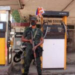 a-member-of-sri-lankan-security-personnel-stands-guard-as-a-fuel-station-ran-out-of-gasoline-in-colo-srilanka