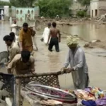 Balochistan flood – people with house hold goods – protecting from water