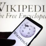 In this photo illustration a Wikipedia logo is seen on a