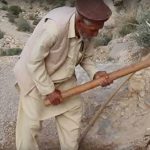 old man with diging tools