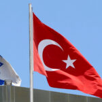 A Turkish flag flutters atop the Turkish embassy as an Israeli flag is seen nearby, in Tel Aviv, Israel